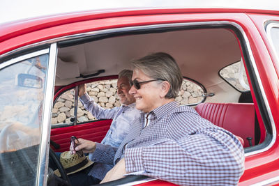 Senior couple traveling in car