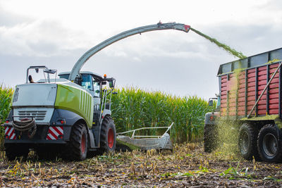 Agricultural machinery on field against sky