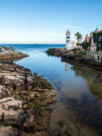 Scenic view of sea and buildings against sky