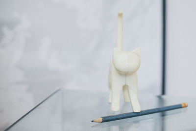 Toy animal and pencil on table
