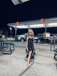 Side view of girl standing in city