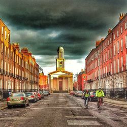 City street against cloudy sky