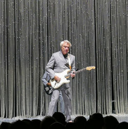 Full length of man playing guitar