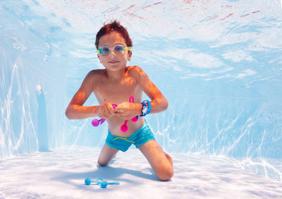 Portrait of young woman swimming in pool