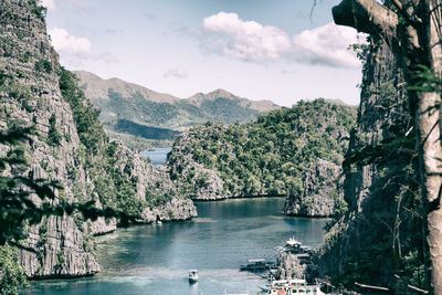 Scenic view of lake and mountains against sky