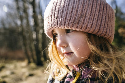 Close-up of girl in red knit hat