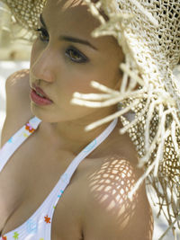 Close-up of young woman in sun hat