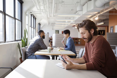 Coworkers working at desks in office