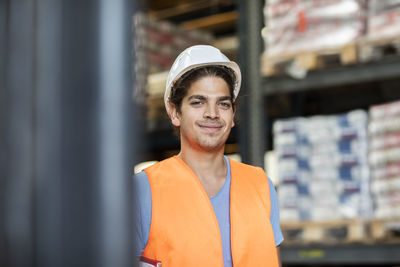 Young store worker with helmet working in a store