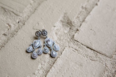 High angle view of earrings on floor