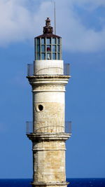 Lighthouse by sea against sky