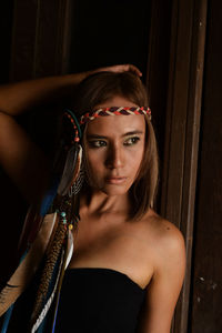 Close-up portrait of young woman at home