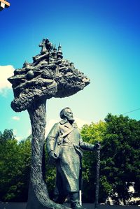 Low angle view of statue against clear blue sky