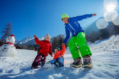 Full length of woman skiing on snow