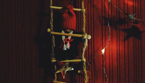 Close-up of red hanging on wooden door