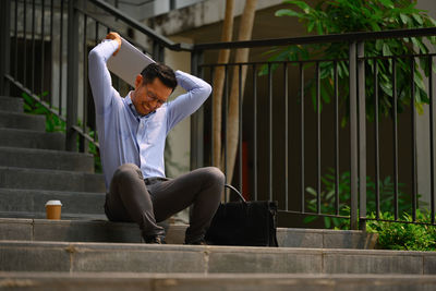 Full length of woman sitting on steps