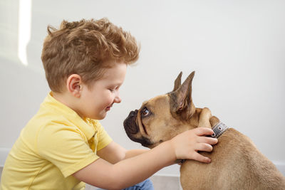 Side view of boy with dog