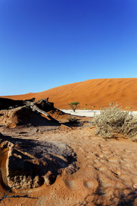 Scenic view of desert against clear blue sky