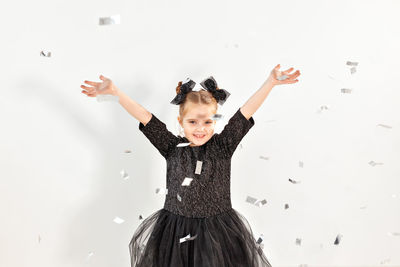 Portrait of happy girl with arms raised