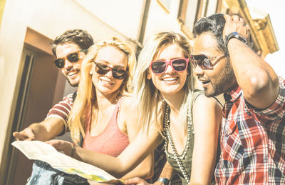 Young man and woman wearing sunglasses