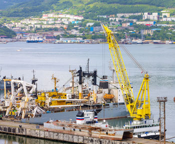 Ships at pier, port cranes on commercial seaport petropavlovsk-kamchatsky