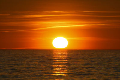 Scenic view of sea against orange sky