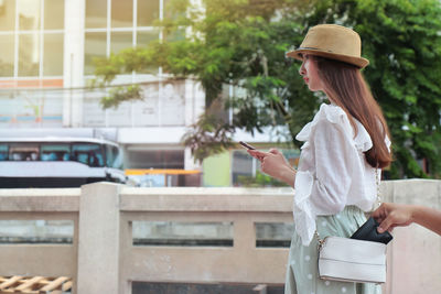 Side view of young woman wearing hat