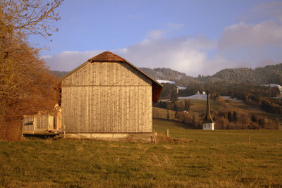 Built structure on field against sky