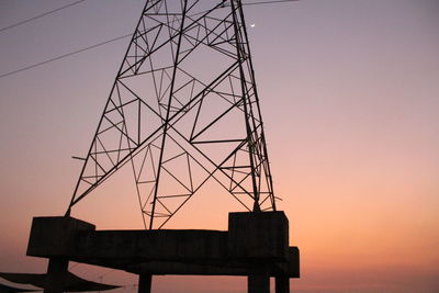 Low angle view of silhouette water tower against clear sky at sunset