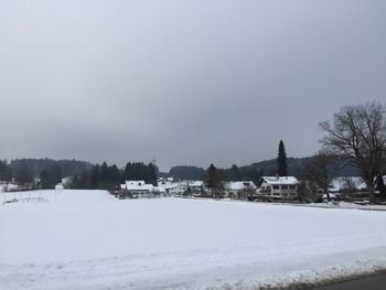 Scenic view of field against sky during winter