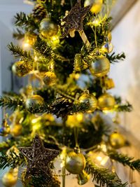 Close-up of christmas decorations hanging on tree