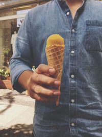 Midsection of man holding ice cream