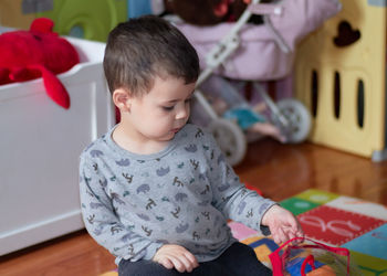 Young boy playing with toys at home