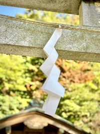 Close-up of cross hanging against wall