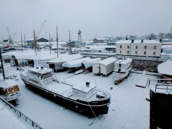 High angle view of boats moored at harbor during winter