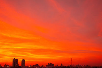 Silhouette buildings against sky during sunset