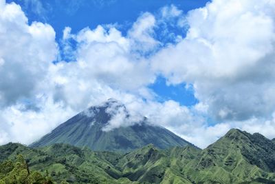 Scenic view of mountains against cloudy sky