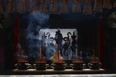 Close-up of incense sticks burning in temple