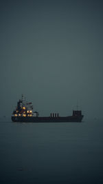 Scenic view of ship in misty sea waters