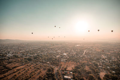 Aerial view of city against sky during sunset