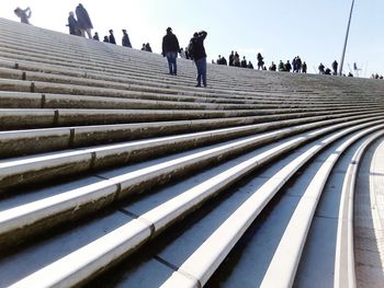 People on steps against sky