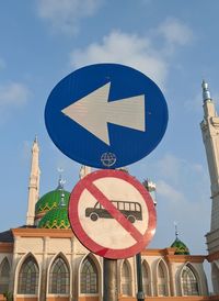 Low angle view of road sign against sky
