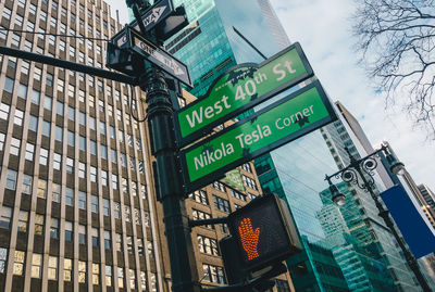 Low angle view of sign and buildings in city