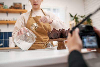 Midsection of woman holding ice cream