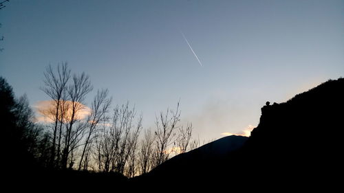 Low angle view of silhouette mountain against sky at sunset