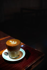 Close-up of coffee on table against black background