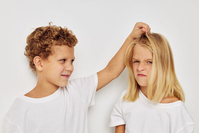 Sibling fighting against white background