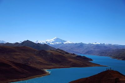 Scenic view of mountain against blue sky