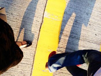 Low section of woman standing on tiled floor