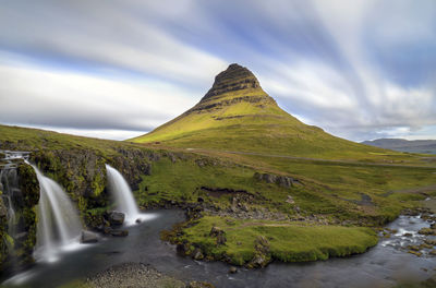 Scenic view of waterfall against sky